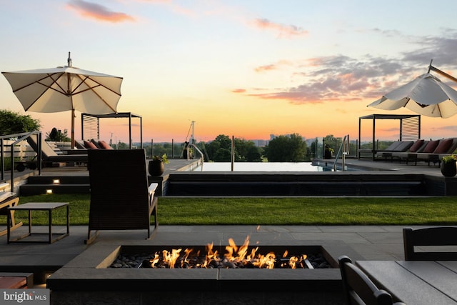 surrounding community with an outdoor fire pit