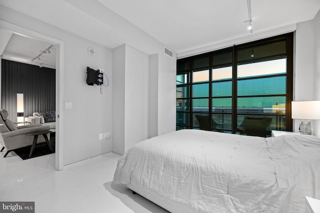 bedroom featuring track lighting and visible vents