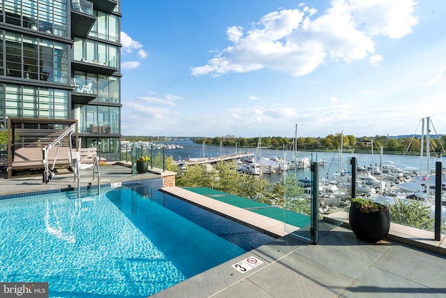 view of pool with a water view