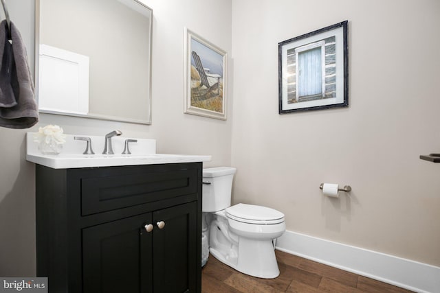 bathroom featuring hardwood / wood-style floors, vanity, and toilet