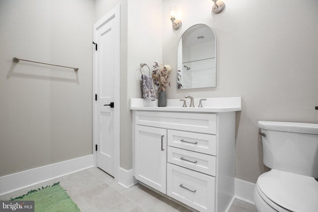 bathroom featuring tile patterned flooring, vanity, and toilet