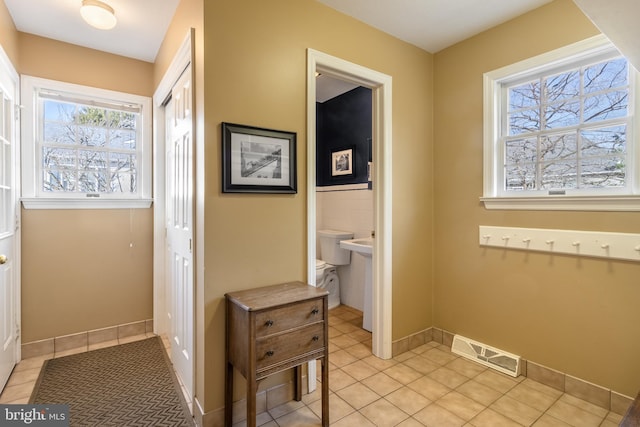 bathroom with tile patterned flooring, visible vents, and baseboards