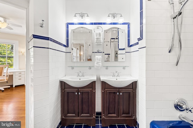 bathroom featuring tiled shower / bath, ceiling fan, vanity, and hardwood / wood-style flooring