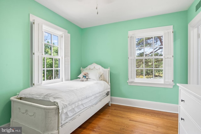 bedroom featuring light hardwood / wood-style flooring and multiple windows