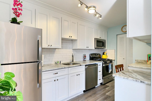 kitchen with white cabinetry, sink, appliances with stainless steel finishes, and tasteful backsplash