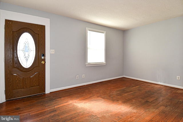 entryway featuring dark hardwood / wood-style flooring and a textured ceiling