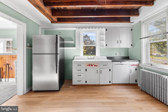 kitchen with white cabinets, stainless steel refrigerator, radiator heating unit, and dishwasher