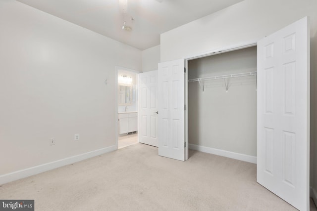 unfurnished bedroom with light carpet and a closet