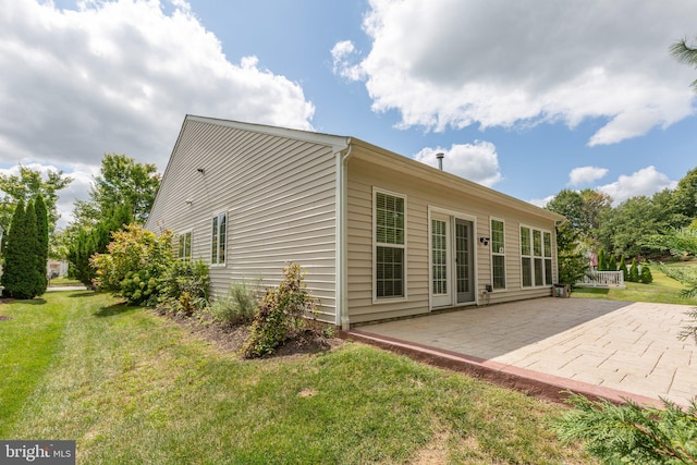 rear view of house with a yard and a patio area