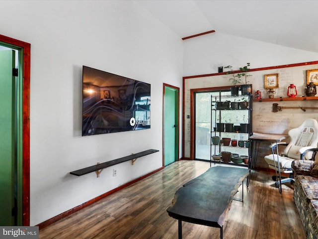 living room with hardwood / wood-style floors and vaulted ceiling