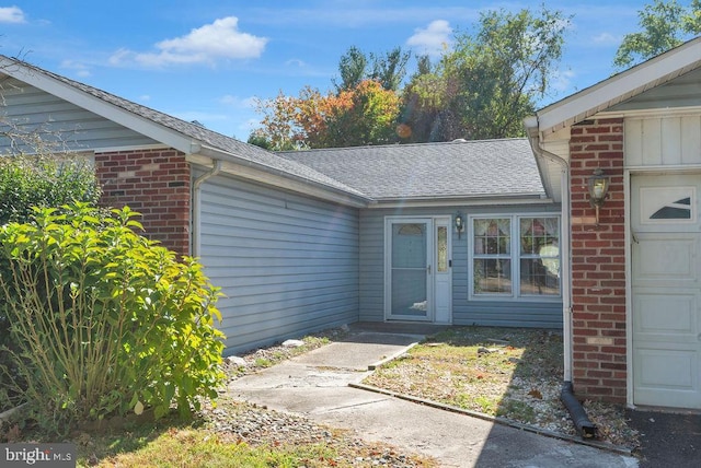 view of exterior entry with a garage