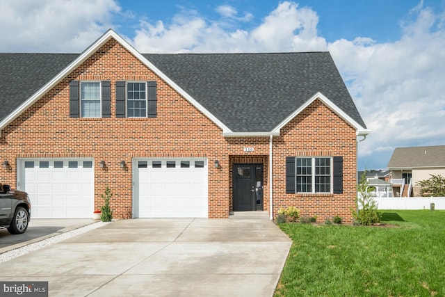 view of front of home with a garage and a front yard