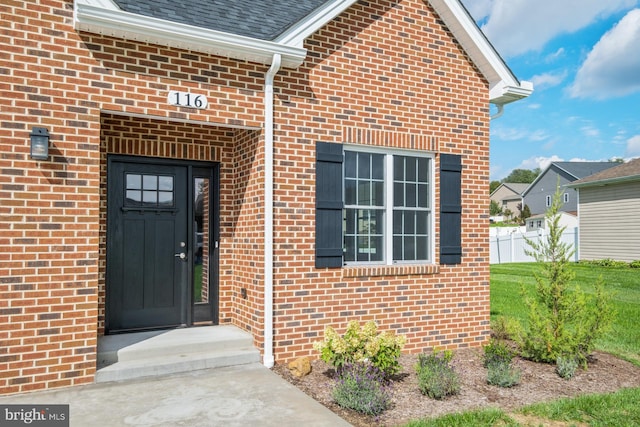 doorway to property featuring a yard