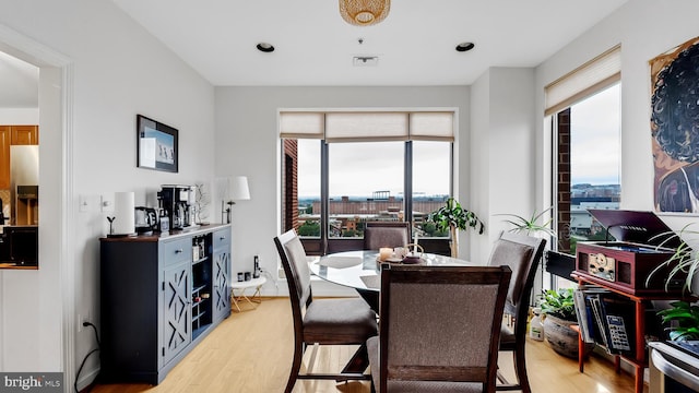 dining space with light hardwood / wood-style flooring