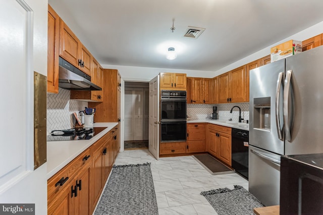 kitchen featuring backsplash, black appliances, and sink