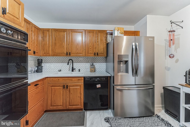 kitchen with backsplash, sink, and black appliances