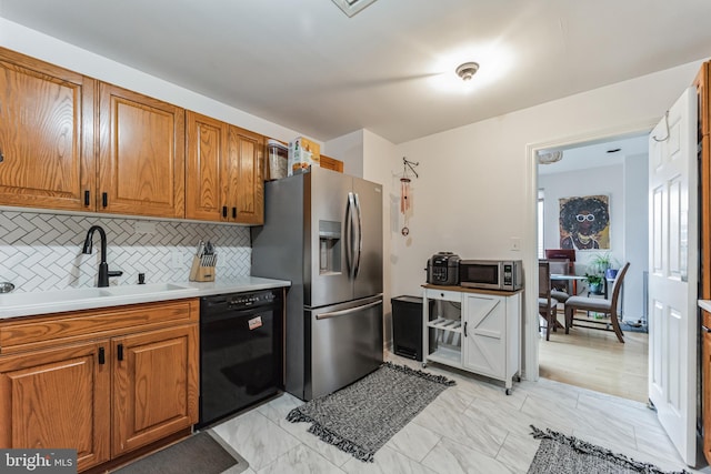 kitchen featuring appliances with stainless steel finishes, sink, and tasteful backsplash