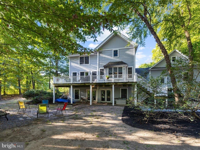 rear view of house featuring a deck and a patio