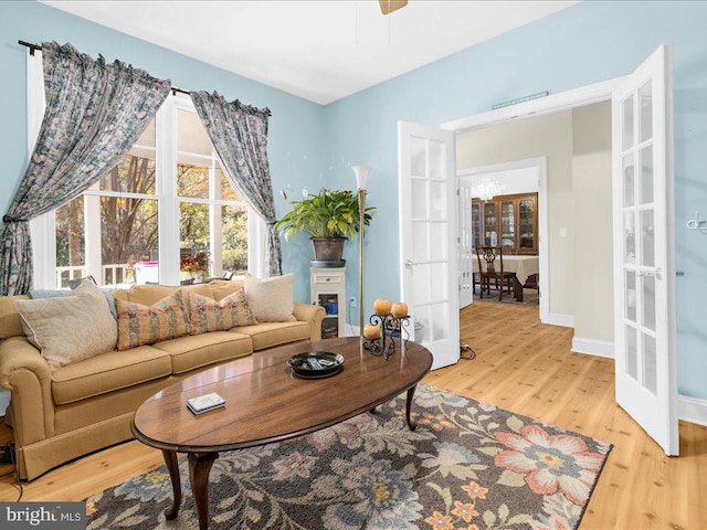 living room with french doors and light hardwood / wood-style floors