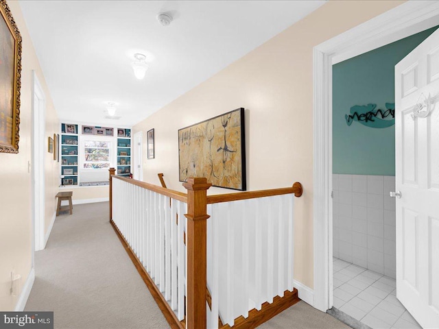 hallway with light colored carpet