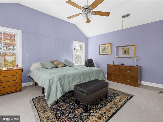 bedroom featuring multiple windows, light colored carpet, lofted ceiling, and ceiling fan