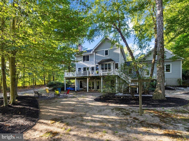 rear view of property featuring a deck