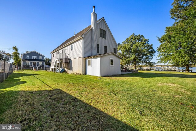 rear view of property with a yard