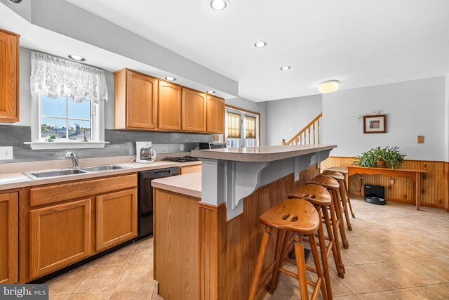 kitchen featuring a wealth of natural light, sink, a center island, and dishwasher