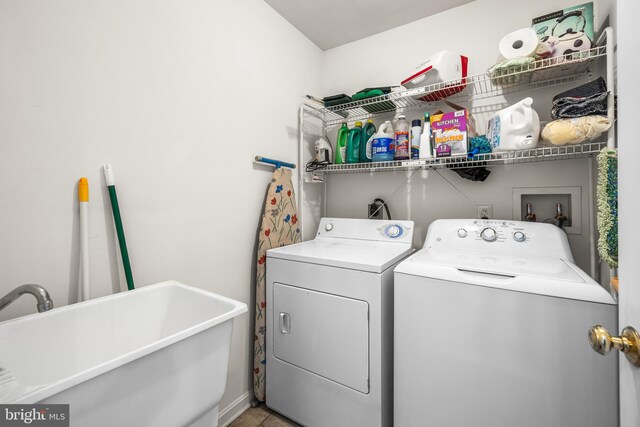 washroom with washing machine and dryer and sink