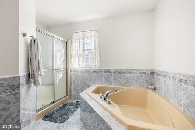 bathroom featuring tile patterned floors and plus walk in shower