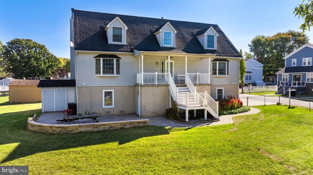 back of house with a yard and a patio area