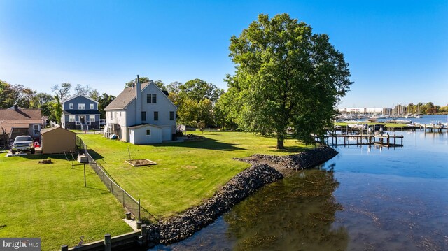 view of dock featuring a yard and a water view