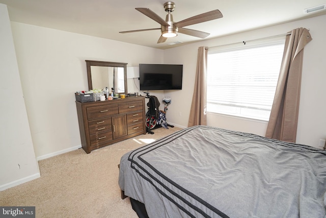 bedroom with light carpet and ceiling fan