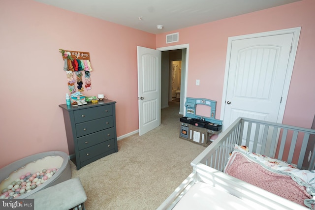 carpeted bedroom featuring a crib