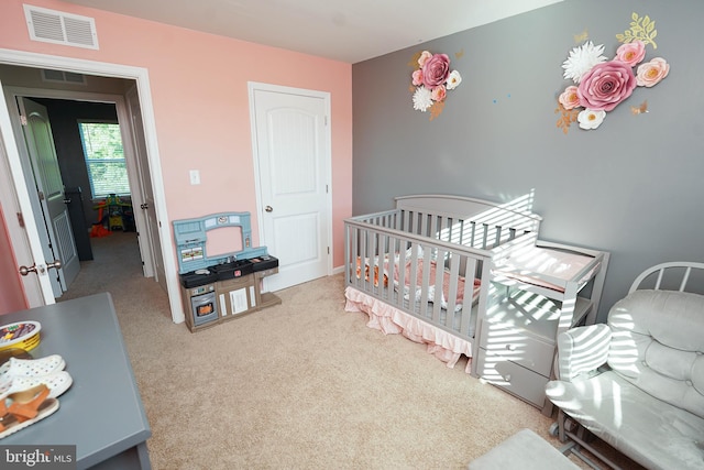 bedroom with light colored carpet and a crib