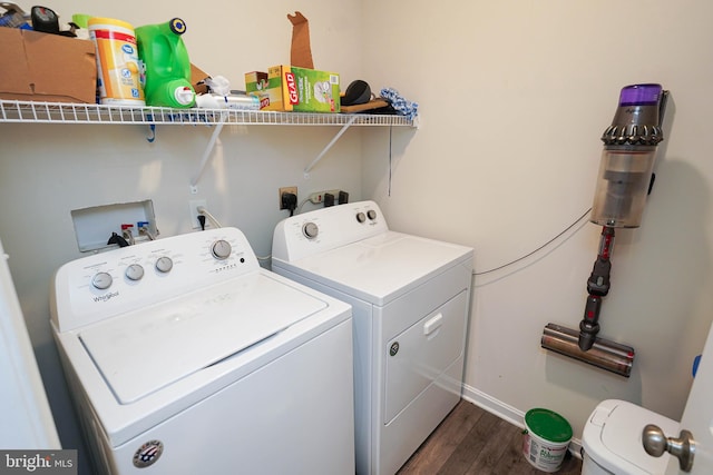 laundry area with independent washer and dryer and dark wood-type flooring