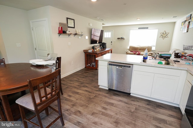 kitchen with sink, dishwasher, white cabinets, and dark hardwood / wood-style floors