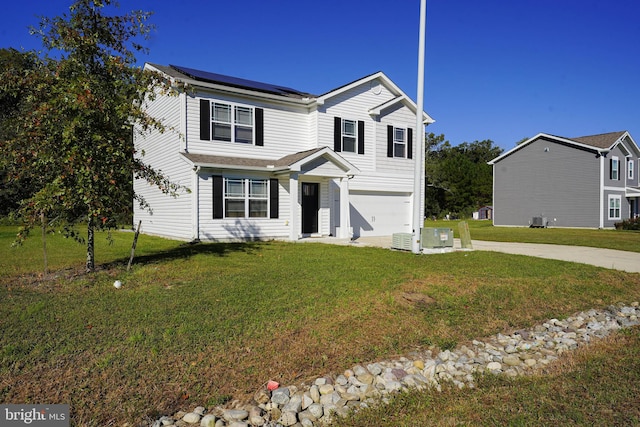 view of front facade with solar panels, a garage, and a front lawn