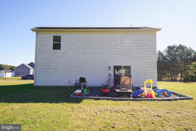 back of house with a lawn