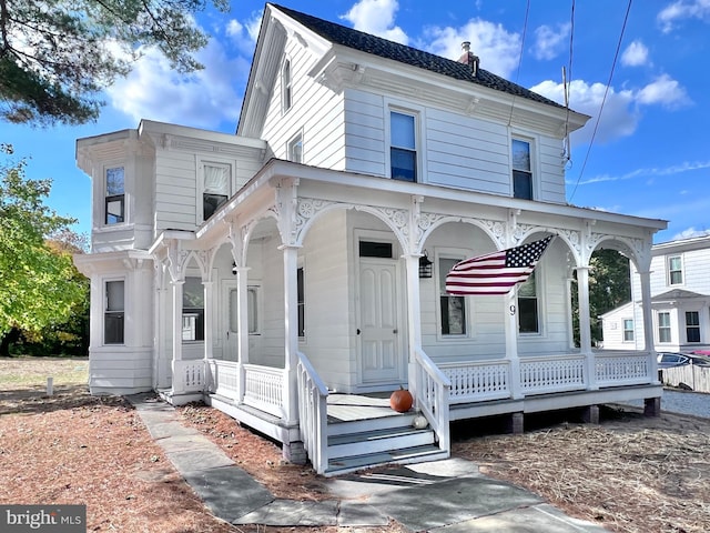 italianate home featuring a porch