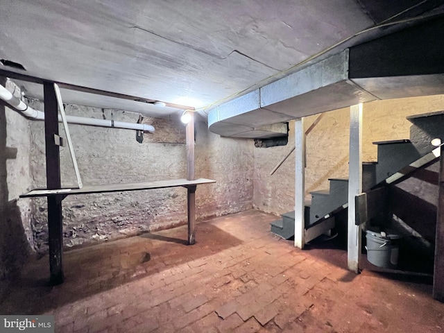unfinished below grade area featuring stairs