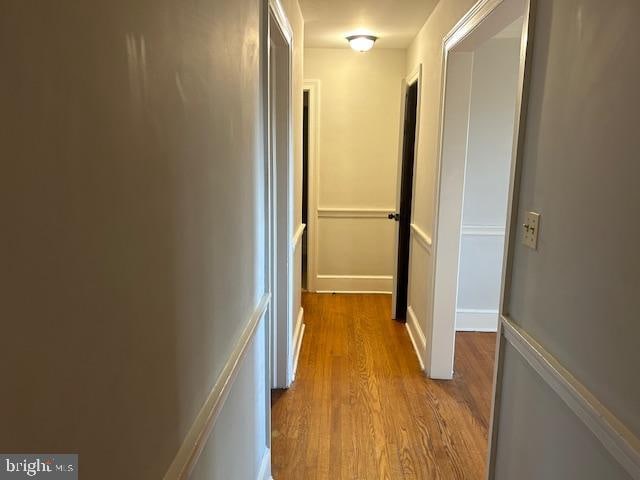 corridor with light hardwood / wood-style floors