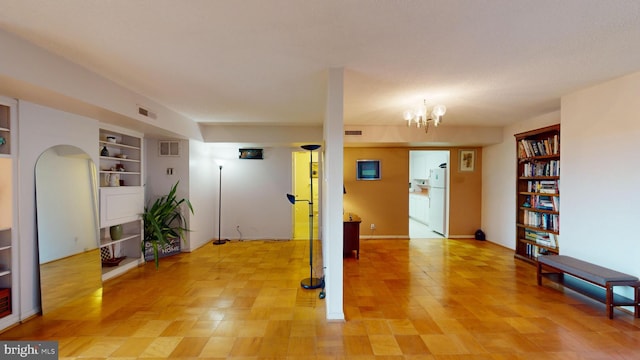 interior space with built in features and a chandelier