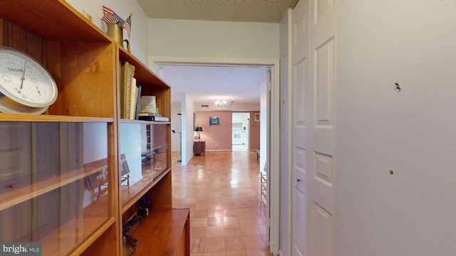 hall featuring a textured ceiling