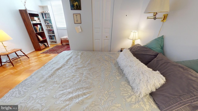 bedroom with a closet and hardwood / wood-style flooring