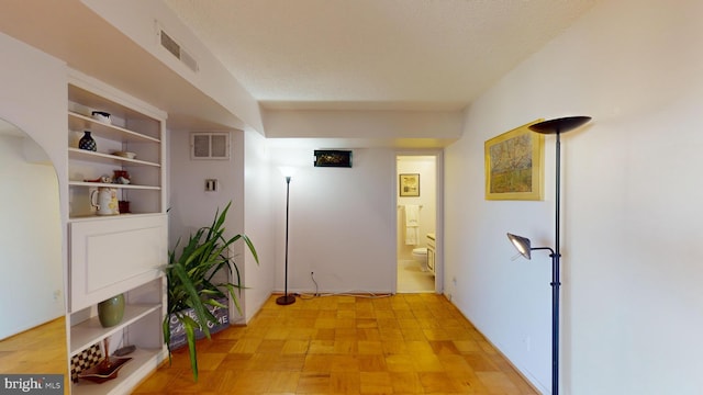 hallway featuring a textured ceiling