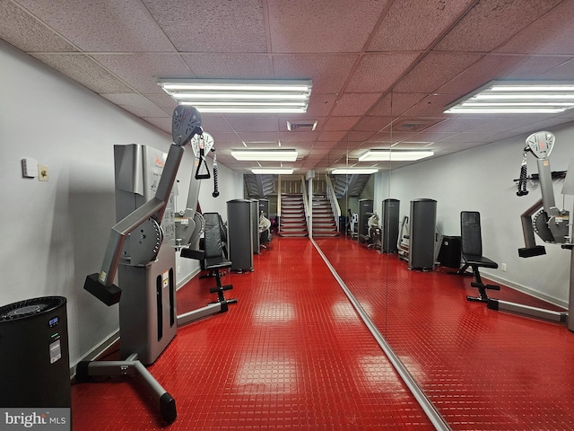 gym with a paneled ceiling