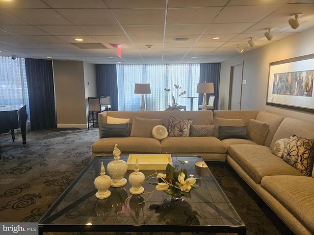 carpeted living room featuring a paneled ceiling and a wealth of natural light