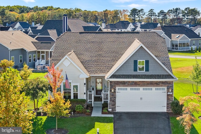 view of front of property featuring a garage and a front lawn