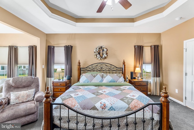 bedroom featuring ceiling fan, a raised ceiling, carpet, and ornamental molding